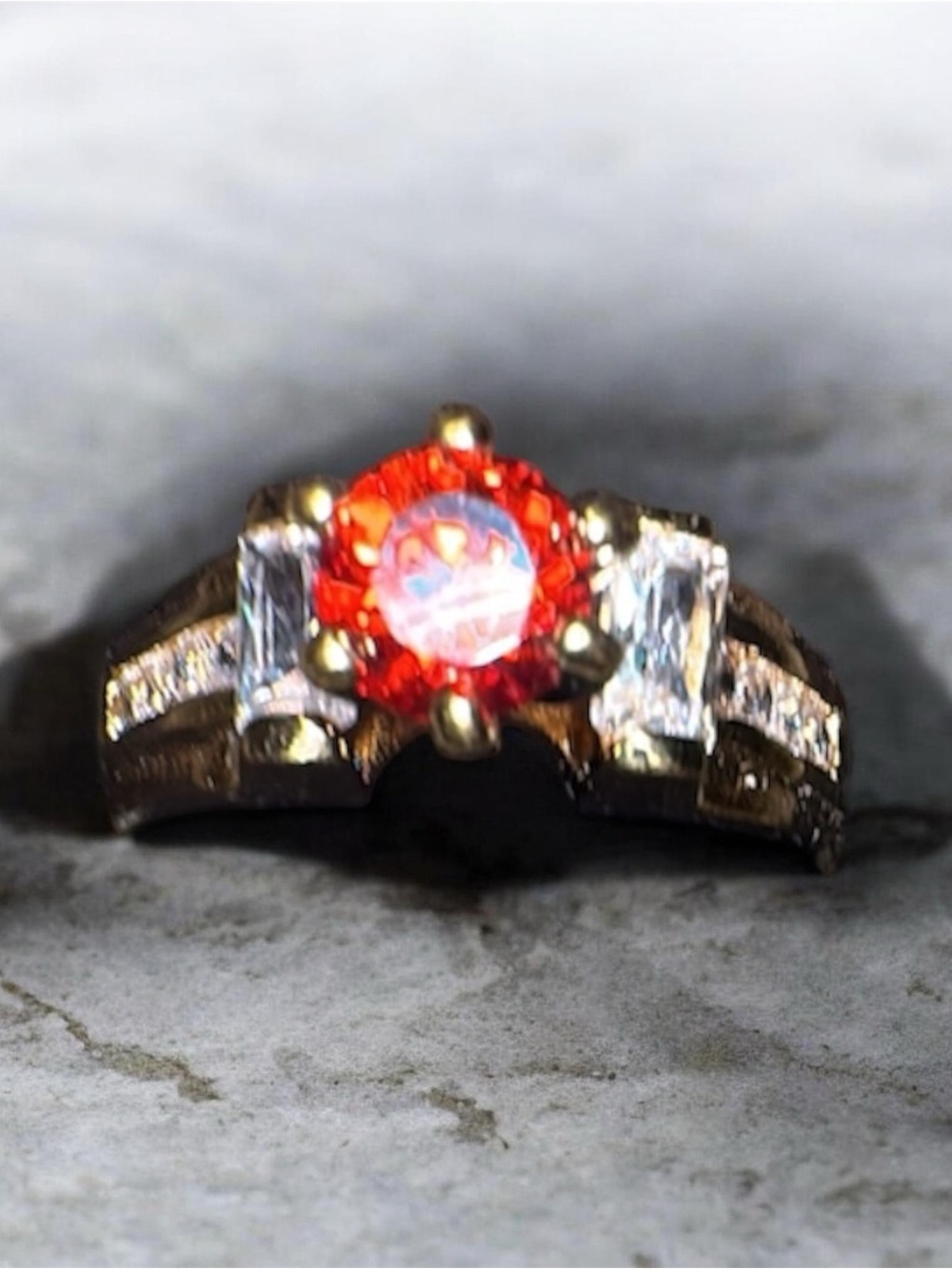 Gold-Tone Ring with Orange Center Stone and Clear Side Stones